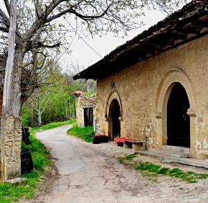 an old stone building with a path next to it at "Pivnica i smestaj Jovanovic"- Rogljevacke pivnice in Rogljevo