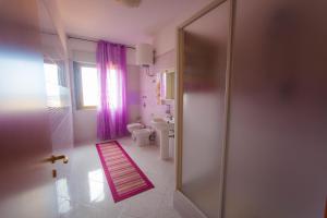 a bathroom with a shower and a toilet and a sink at Casa Vacanze L'Orizzonte in Valderice