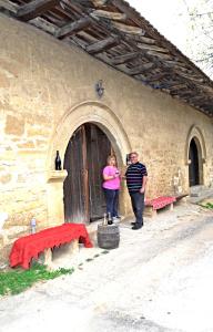 a man and a woman standing outside of a building at "Pivnica i smestaj Jovanovic"- Rogljevacke pivnice in Rogljevo