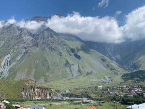 a view of a mountain with clouds on it at Tamila Guest House in Kazbegi