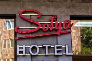 a hotel sign on the side of a building at Sofya in Goris