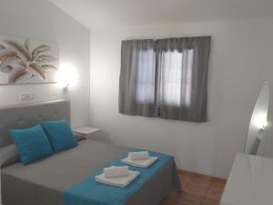 A bed or beds in a room at Santa Barbara by Placida Mar
