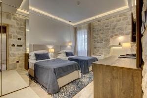 Postel nebo postele na pokoji v ubytování Heritage Hotel Leon Coronato