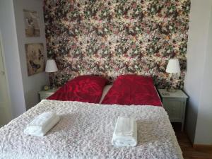 a bedroom with a bed with a floral wall at Guesthouse Lokinlaulu in Kotka +29 photos
