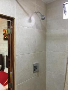 a shower with a shower head in a bathroom at Miraflores Centre in Lima