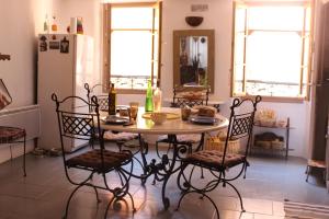 グラースにあるDuplex spacieux avec terrasse - Centre Historique de Grasseのキッチン(テーブル、椅子、冷蔵庫付)