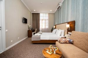 TV a/nebo společenská místnost v ubytování Margi Boutique Hotel by DNT Group