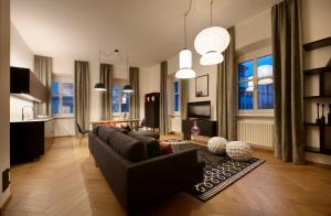 a living room with a couch and a table at Arte Apartments in Bolzano