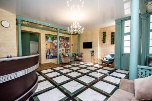 a living room with a chandelier and a lobby at Margi Boutique Hotel by DNT Group in Tbilisi City