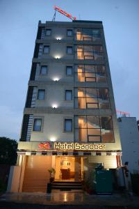 a building with a hotel sign on the front of it at Hotel Sanobar in Udaipur