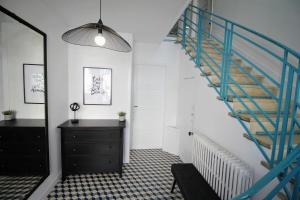 a staircase in a room with a dresser and a black cabinet at Villa Centre ville in Arcachon