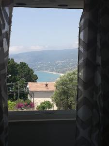 a window with a view of a body of water at Stella marina in Palinuro