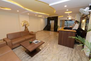 a living room with a couch and a bar at Hotel Sanobar in Udaipur
