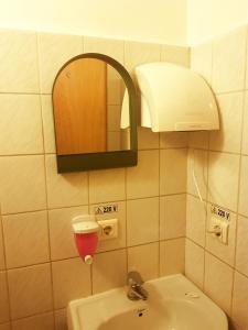 a bathroom with a sink and a mirror at Sleep Inn Hostel in Bucharest