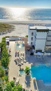an aerial view of a resort with a swimming pool and the beach at Barefoot Beach Club in St. Pete Beach