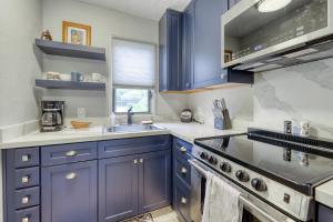 a kitchen with blue cabinets and a sink at Kona Bali Kai #165 in Kailua-Kona