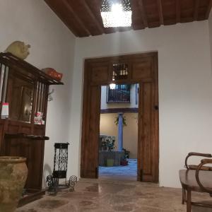 a room with two wooden doors and a room with a table at Alh Patio Apartamentos in Granada