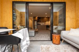 a living room with a couch and a table at Penthouse with Park View in Christchurch