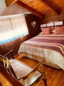 a bedroom with a bed and a chair at Casamia Altos in Bahía Blanca