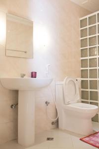 a white bathroom with a sink and a toilet at Jasmin's Room Rental in Moalboal