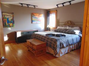 a bedroom with a large bed and a window at Paradise Acres Ranch in Nanoose Bay