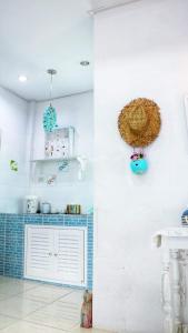 a kitchen with white walls and blue tiles at Prathana Garden Beach Resort in Hua Hin