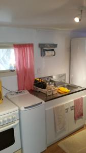 a kitchen with a stove and a stove top oven at le bungalow au fond du jardin in Valeille +11 photos