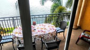a table and chairs on a balcony with the ocean at Beach and Bay MediterraneanTownhouse in St Pete Beach