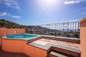 a balcony with a swimming pool on top of a building at Casa Rosada in Massa Lubrense