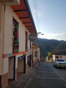 a building with a car parked on a street at Hotel La Posada in Belén de Umbría