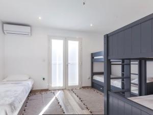 a bedroom with two bunk beds and a window at Villa Ondines in Les Anses-dʼArlets