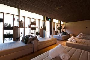 a large living room with couches and windows at The Hide Flims Hotel a member of DESIGN HOTELS in Flims
