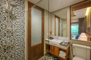 a bathroom with a sink and a mirror at Sagara Candidasa in Candidasa