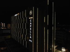 a sign on the side of a building at night at Capella Otel in Eskisehir