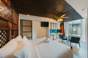 a bedroom with a large bed with a ceiling fan at Minh Boutique in Danang