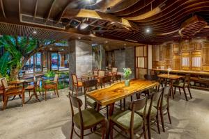 a dining room with wooden tables and chairs at Minh Boutique in Danang