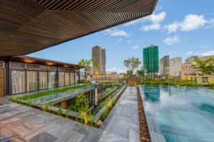 a swimming pool with a city skyline in the background at Minh Boutique in Danang