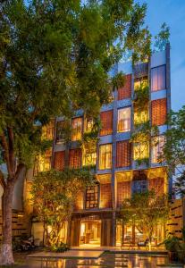 a large building with trees in front of it at Minh Boutique in Danang