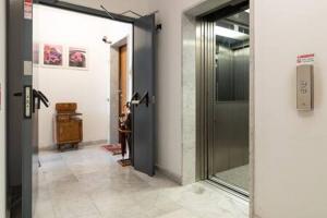 a hallway with a glass door in a room at Airport Malpensa GALLARATE in Gallarate