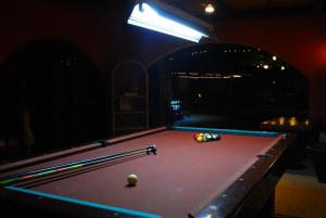 a pool table with a ball on top of it at Playa Papagayo Beach Inn in Olongapo