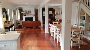 a kitchen and living room with a table and chairs at Bowral Escape in Burradoo