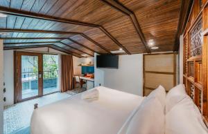 a bedroom with a white bed and a desk at Minh Boutique in Danang