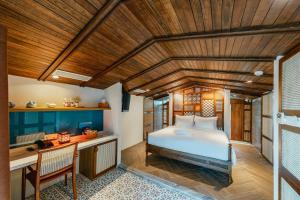 a bedroom with a bed and a desk in a room at Minh Boutique in Danang +37 photos
