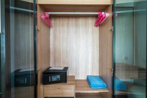 a room with a closet with pink umbrellas at The Deck Condominium by Lofty in Patong Beach