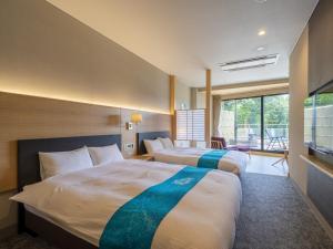 Säng eller sängar i ett rum på Hotel Sekisuien