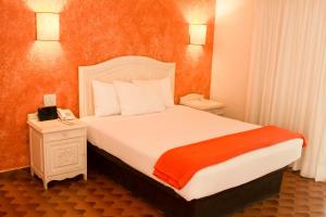 Säng eller sängar i ett rum på Hotel Villa del Conquistador