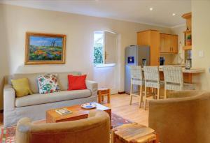 a living room with a couch and a kitchen at No.8 on Wright Street in George