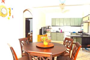 a kitchen with a table and chairs and a dining room at Villa Samaara9 Candolim Beach in Candolim