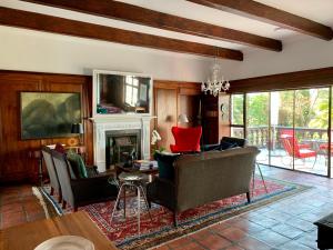 a living room with a couch and chairs and a fireplace at Le Must Residence in Upington