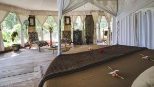 a bedroom with a large bed in a room at Sandat Glamping Tents in Ubud
